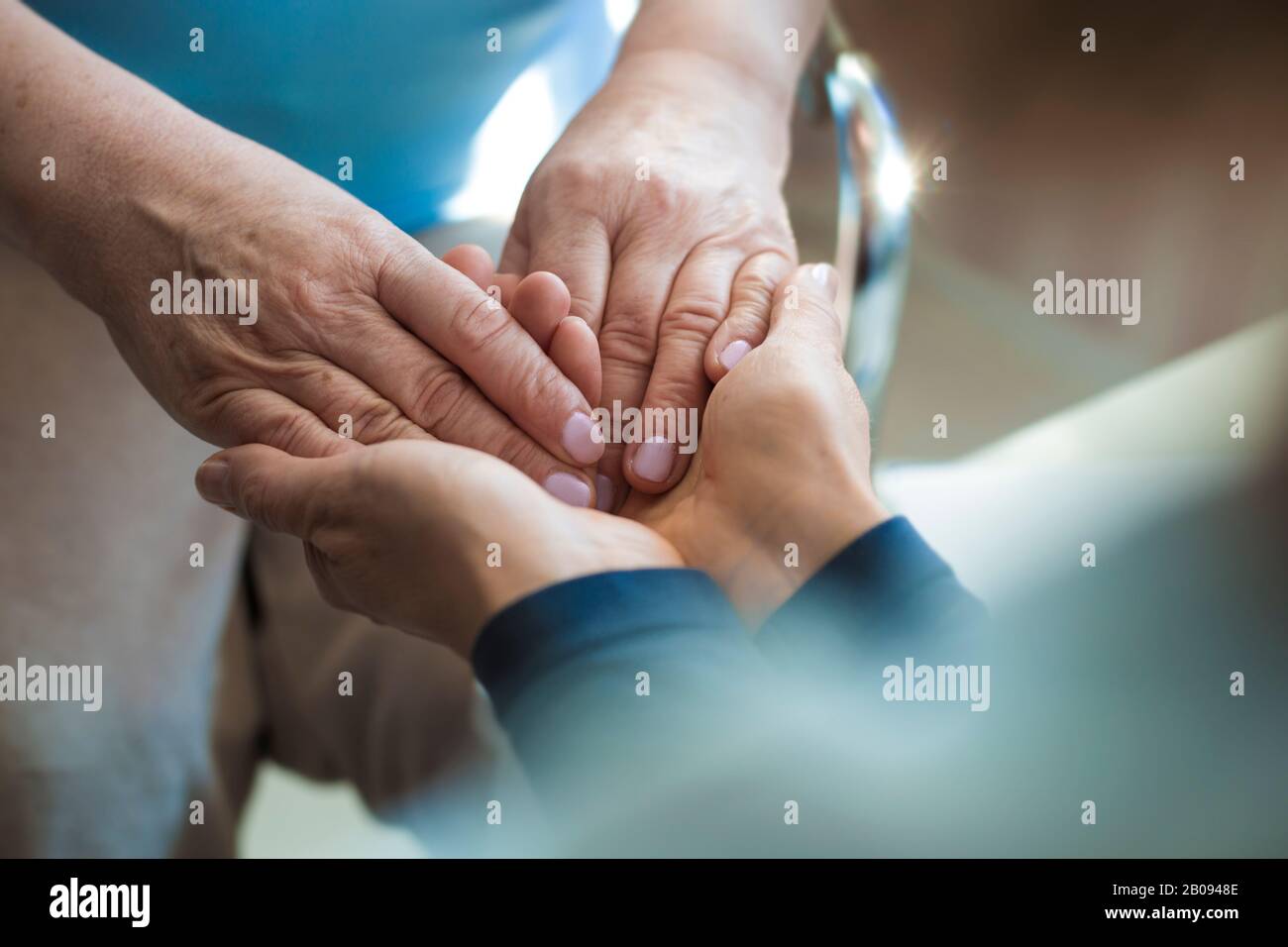 Hands of a mature woman or caregiver of care and support. Close-up. Stock Photo