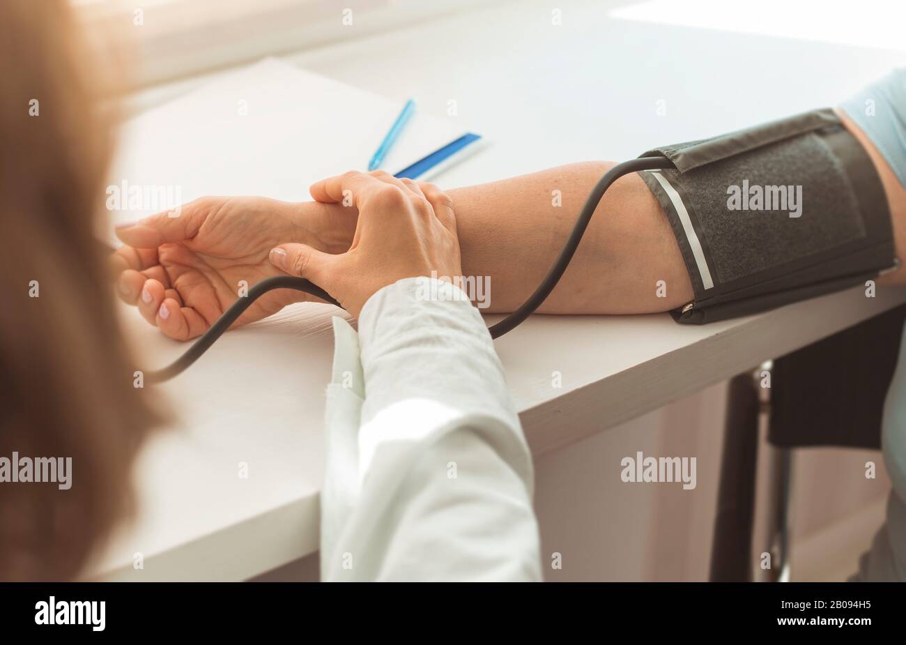 Doctor measuring blood pressure. Stock Photo
