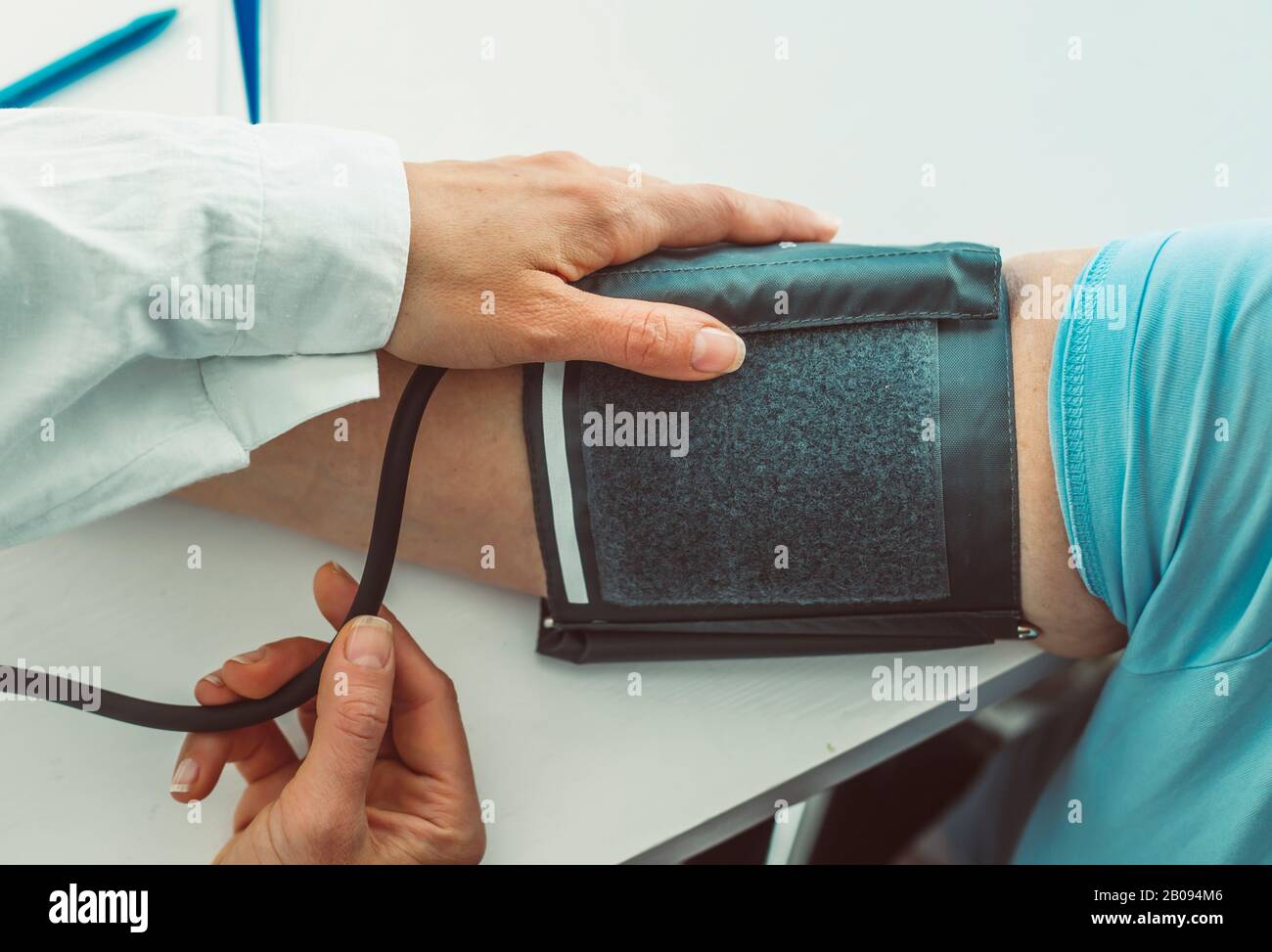 Doctor measuring blood pressure. Stock Photo