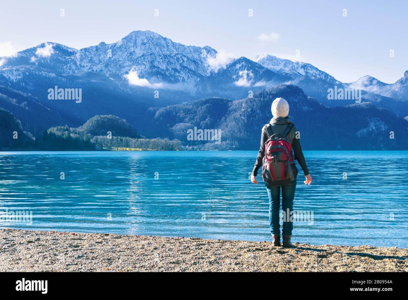 The girl relaxes near the lake and mountains. Stock Photo
