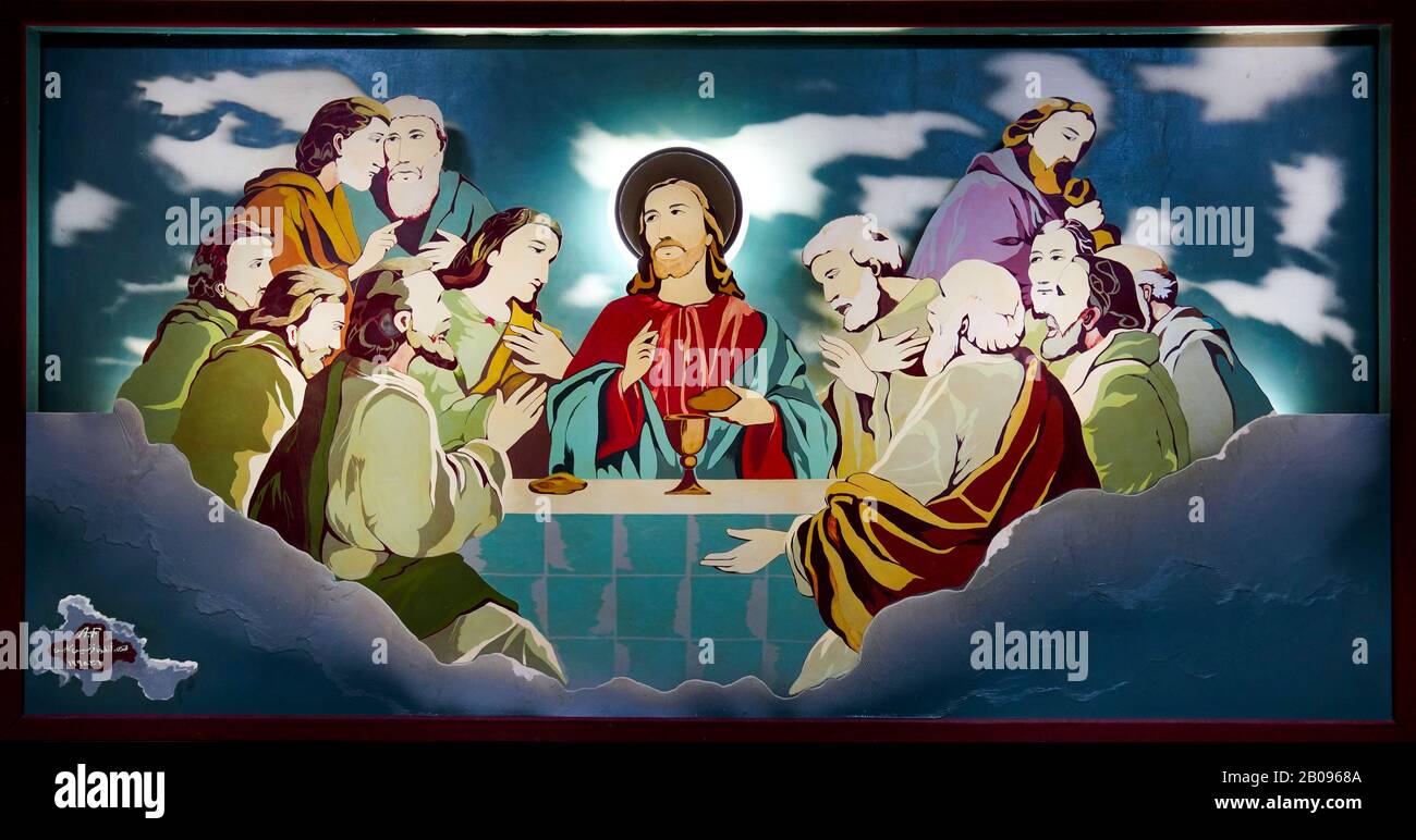 Priests eat supper under a religious oil painting "The Last Supper of