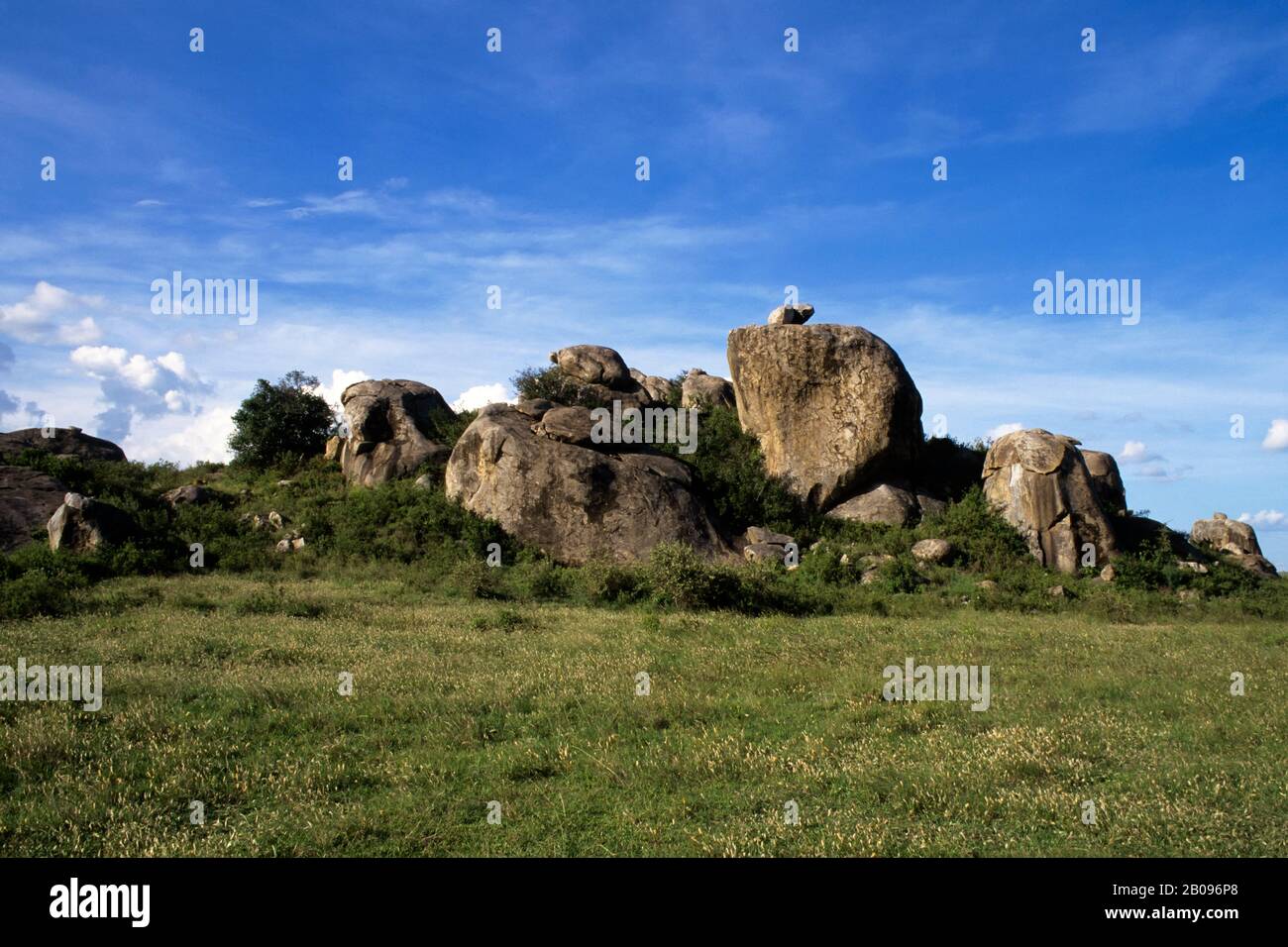 TANZANIA, SERENGETI, GRASS PLAIN WITH KOPJE (ROCK FORMATION Stock Photo ...