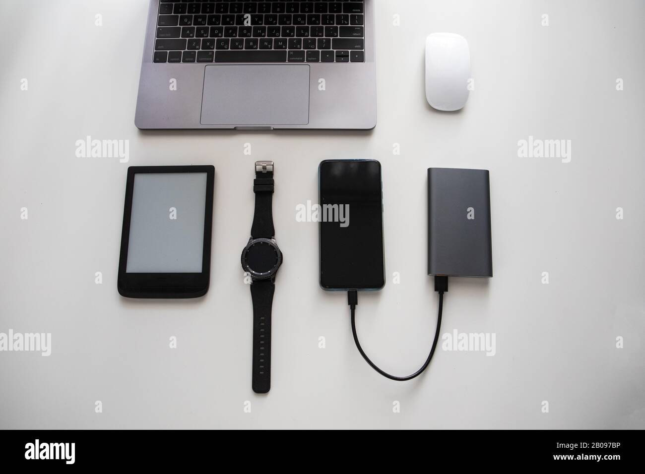 flatlay of different objects as laptop computer mouse phone smart watch ...