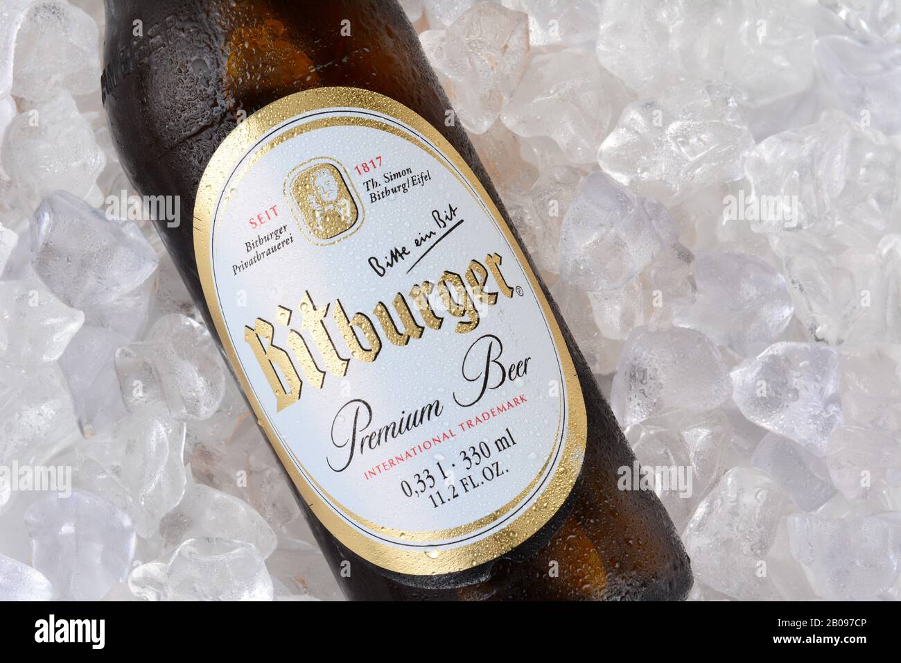 IRVINE, CA - JANUARY 11, 2015: A closeup of a bottle of Bitburger Beer on a bed of ice. Bitburger is a German family business with around  that in 201 Stock Photo