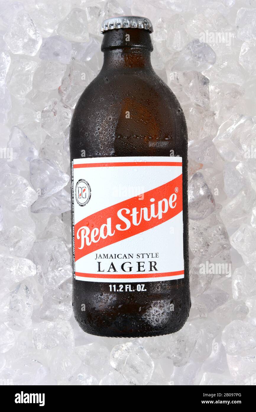IRVINE, CA - JANUARY 11, 2015: A bottle of Red Stripe Jamaican Style Lager on a bed of ice. Brewed in Jamaica since 1938 by Desnoes & Geddes its inter Stock Photo