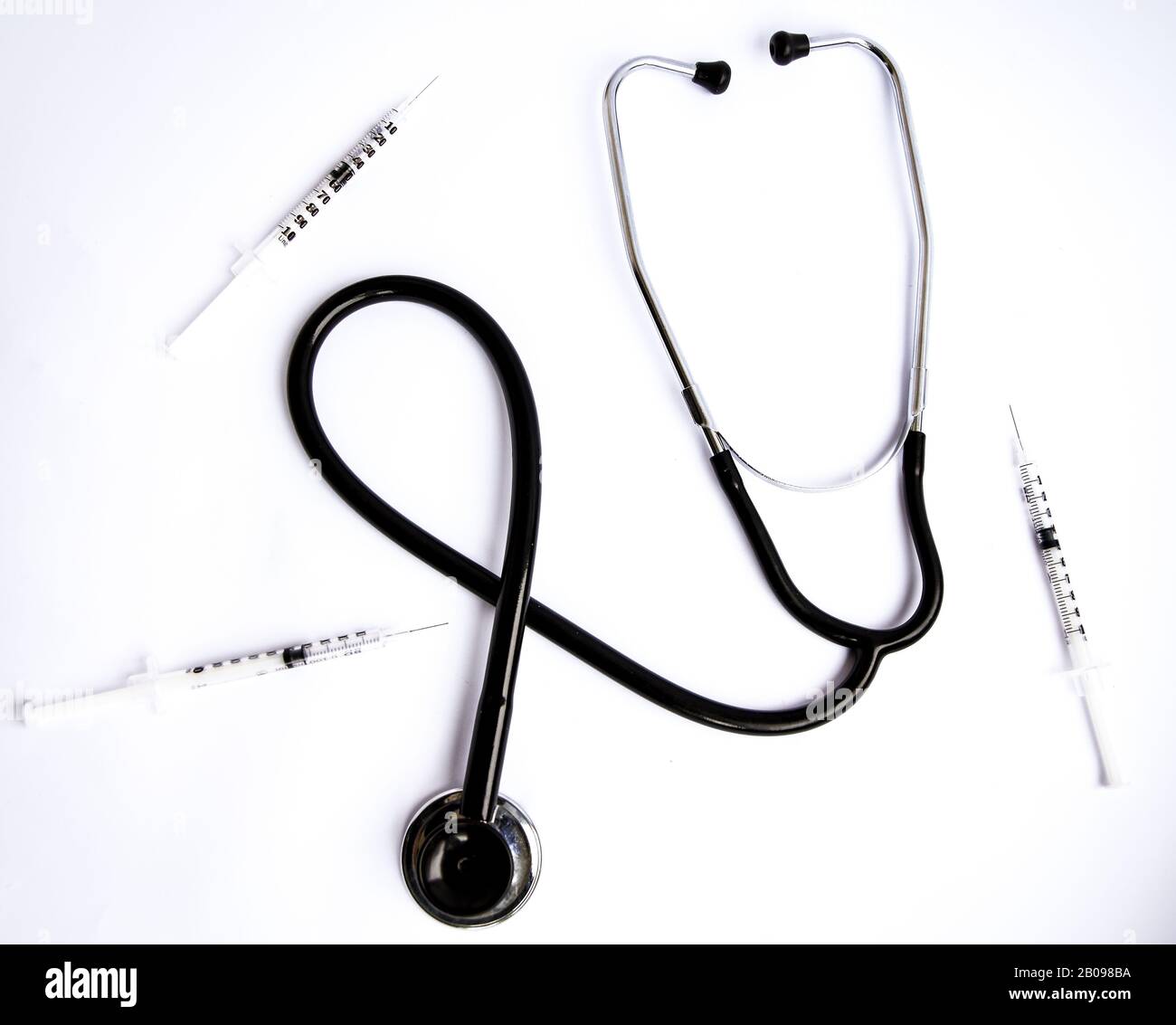 Medical stethoscope with syringes on white background Stock Photo - Alamy