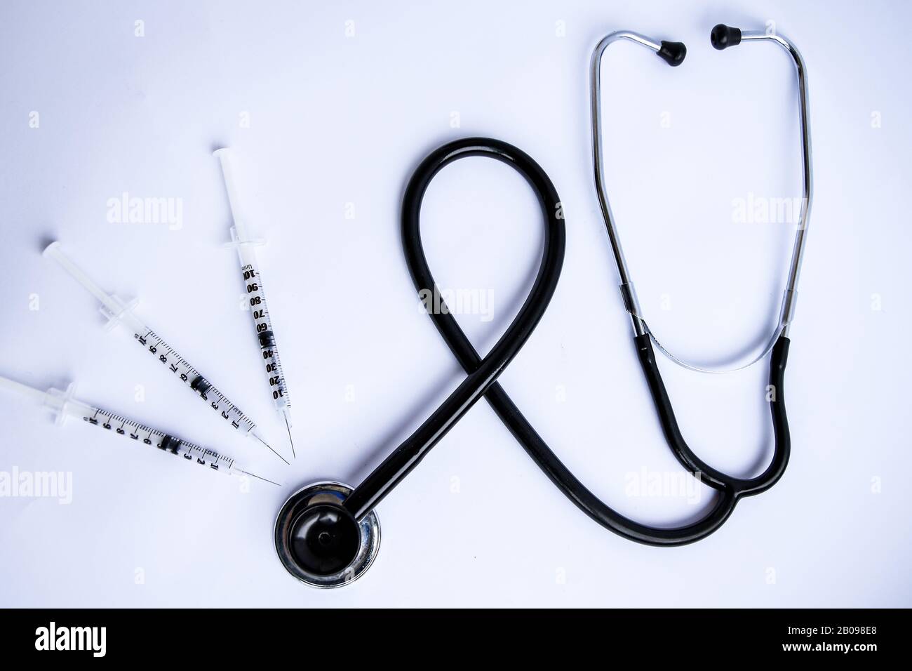 Medical stethoscope with syringes on white background Stock Photo - Alamy