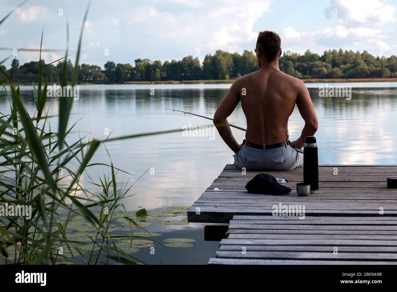 A beautiful man with a bare cake with a fishing rod Stock Photo
