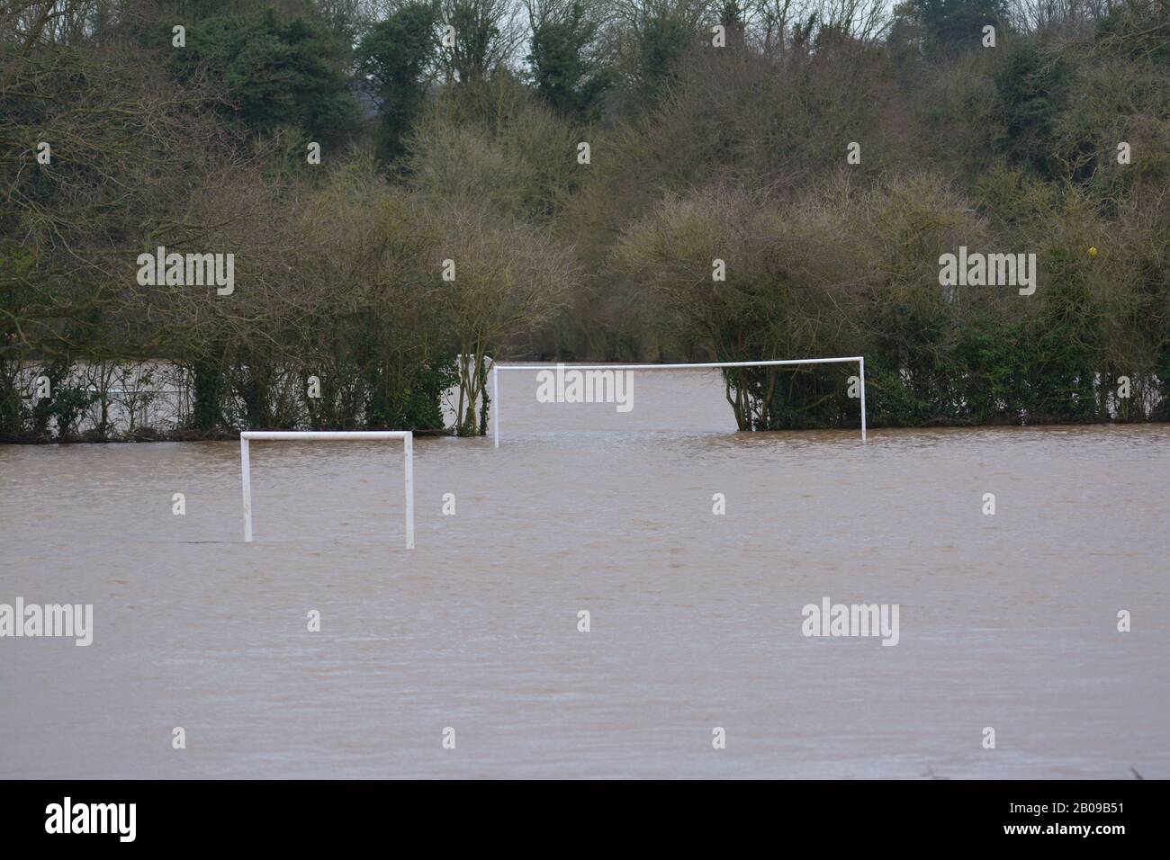 River Wye burst its banks at Ross-on-Wye Herefordshire UK with water covering playing fields football pitch re flooding global warming climate Stock Photo
