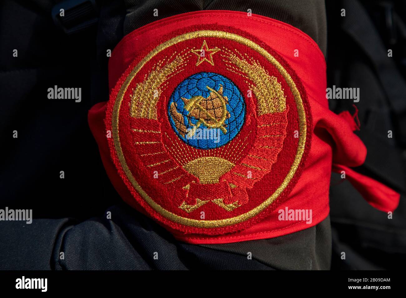 A man in an armband with the image of the coat of arms of the USSR Stock Photo