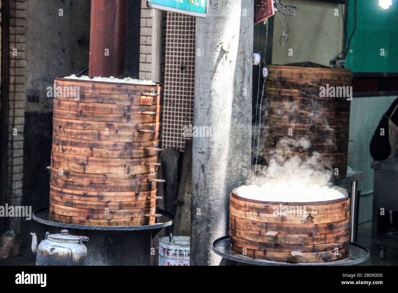 Street food in china. Dumplings cooking inside traditional bamboo steamers, Xian Stock Photo
