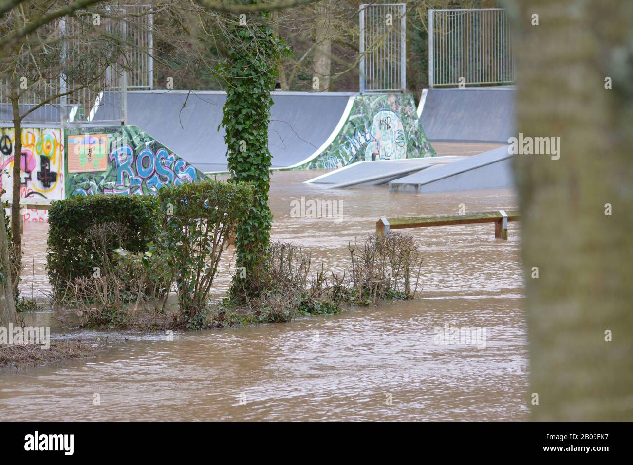 River Wye burst its banks at Ross-on-Wye Herefordshire UK with water covering fields and skate park re flooding global warming climate Stock Photo