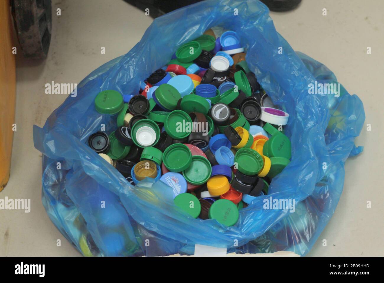 21.12.2019, Russia, Syktyvkar, collection of plastic caps from drinking bottles for recycling. Environmental protection concept, informed consumption. Stock photo with empty space for text. Stock Photo