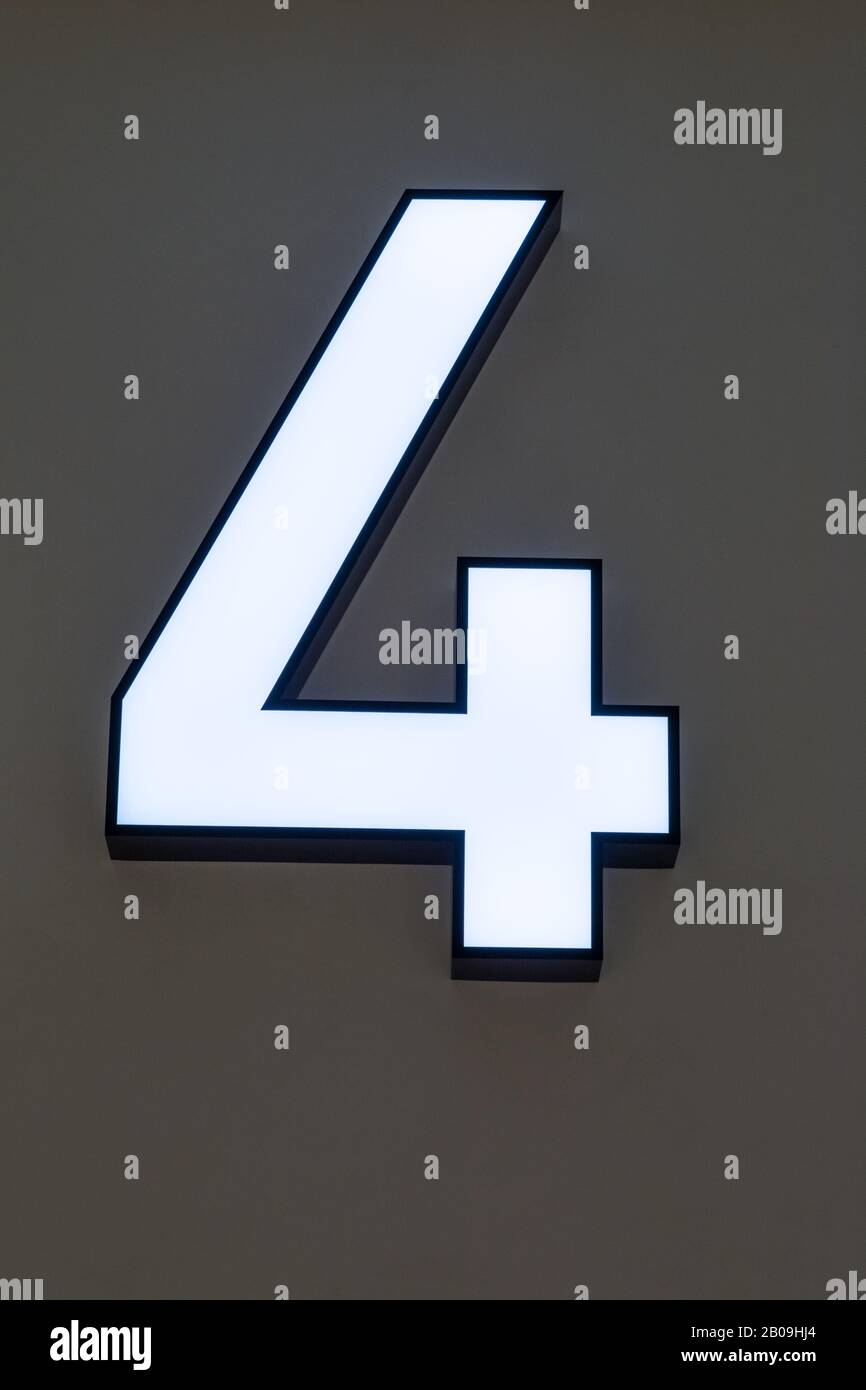 Number 4 Neon sign on the wall Stock Photo