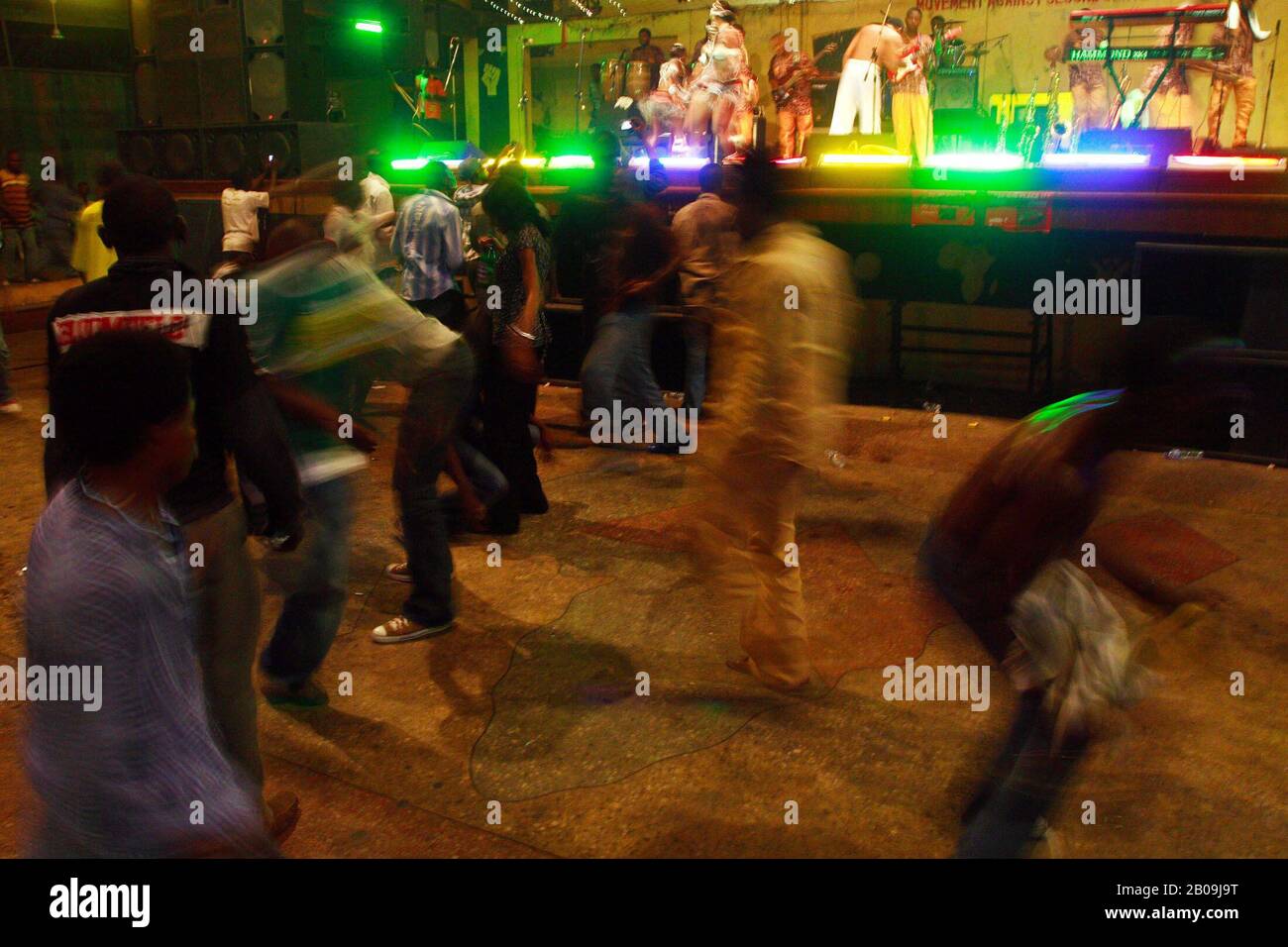 Fans of Femi Kuti dance at the Afrika Shrine during regular Sunday jump night show where revelers coming to unwind after all the weeks bustle and hustle, as Femi Kuti son of  late Fela Kuti the Afrobeat legends plays to the delight of the people. Lagos, Nigeria, 2006. Stock Photo