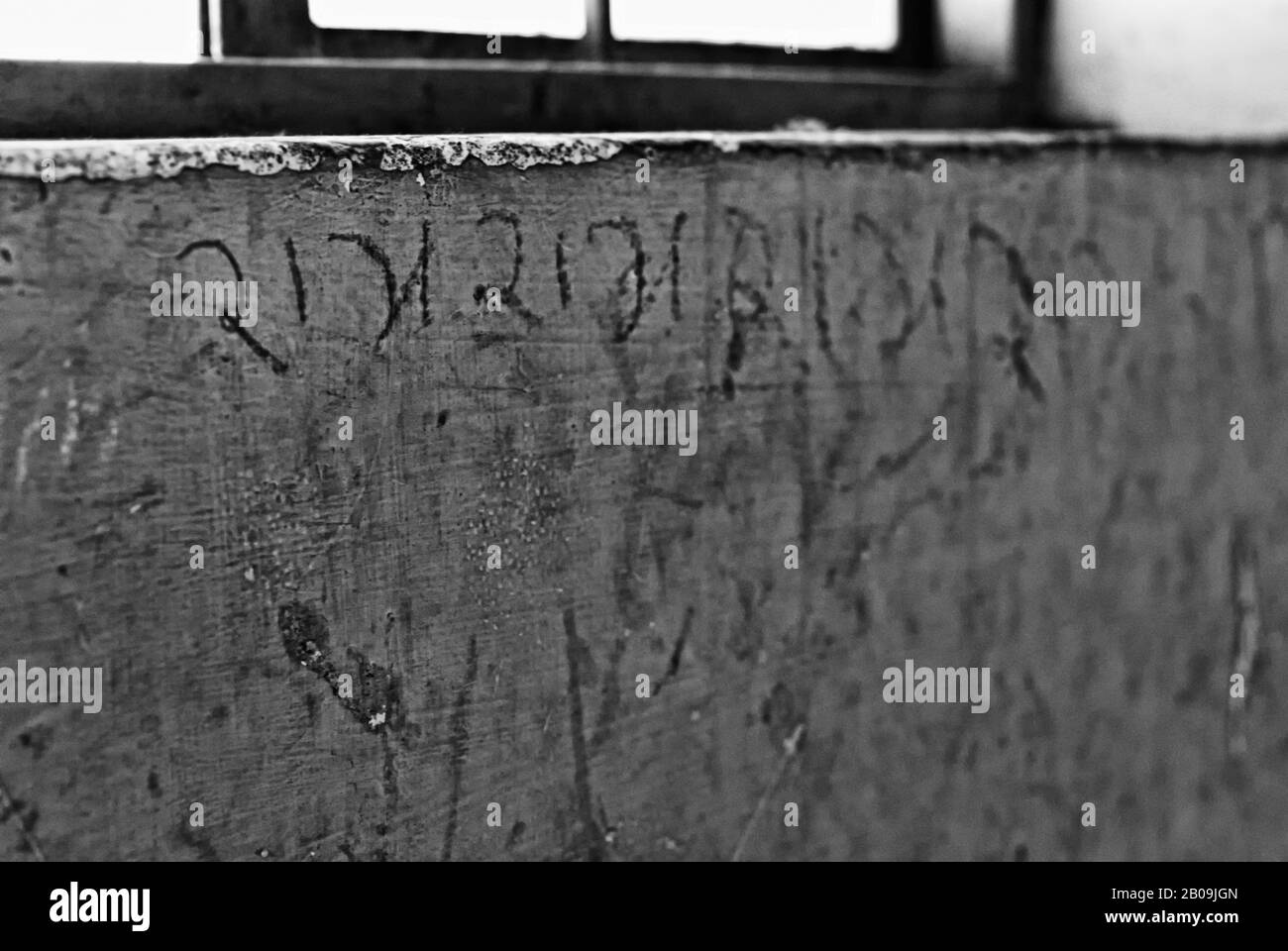 The word ‘Ram’ (Lord Ram - seventh avatar of God Vishnu in Hindu religion) is written repeatedly by an inmate, on the wall of a ward, at the Beggars’ Home, on Magadi Road, Bangalore, Karnataka, India. December 22, 2012. One of a set of images from the photo story, Criminalizing Poverty, by Ayush Ranka. Stock Photo