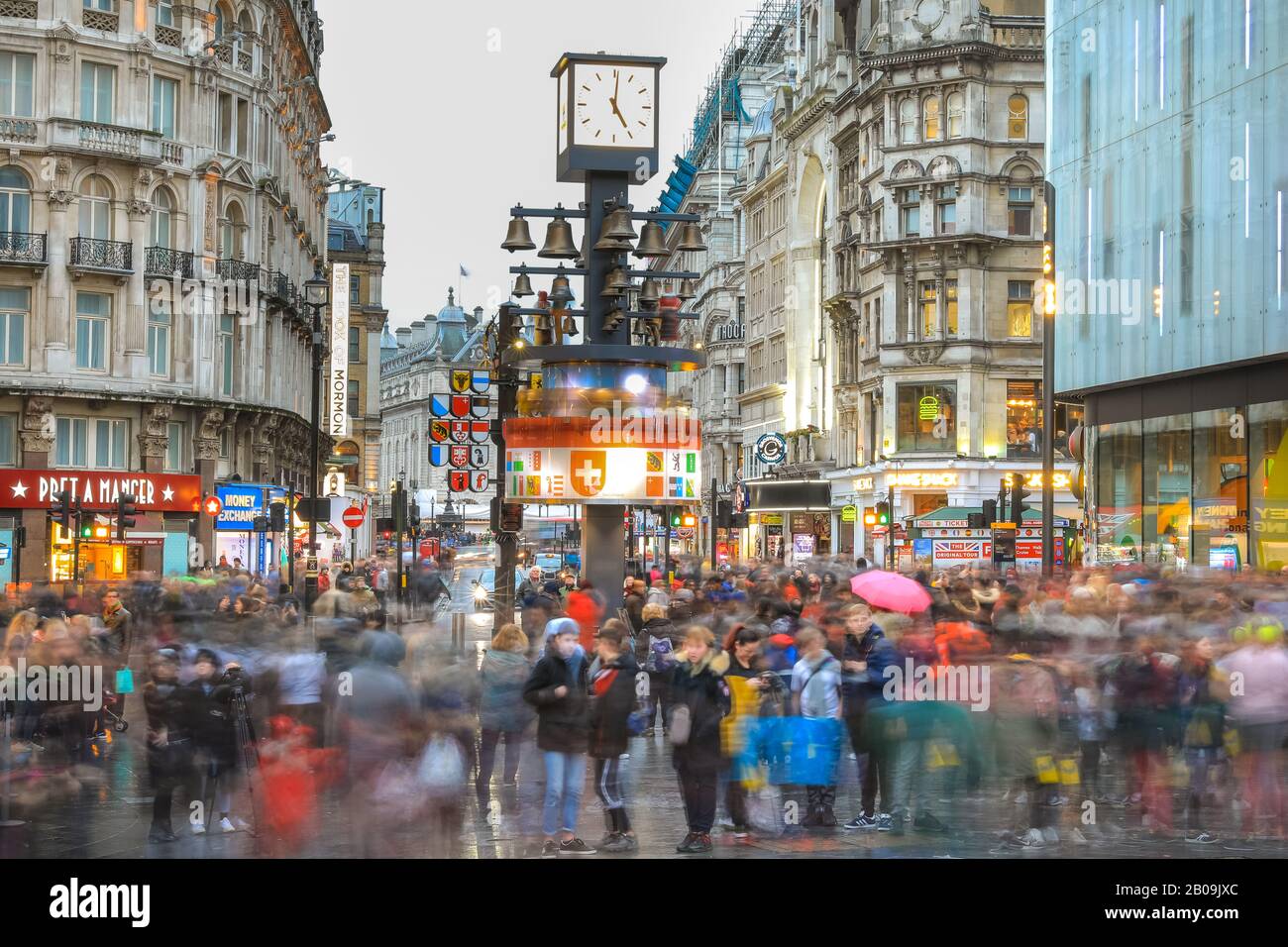 West End, London, UK. 19th Feb, 2020. Tourists make the most of the weather on London's Leicester Square. Tourists and Londoners enjoy the short gaps in the rain on a wet but mild day in London's West End. Credit: Imageplotter/Alamy Live News Stock Photo