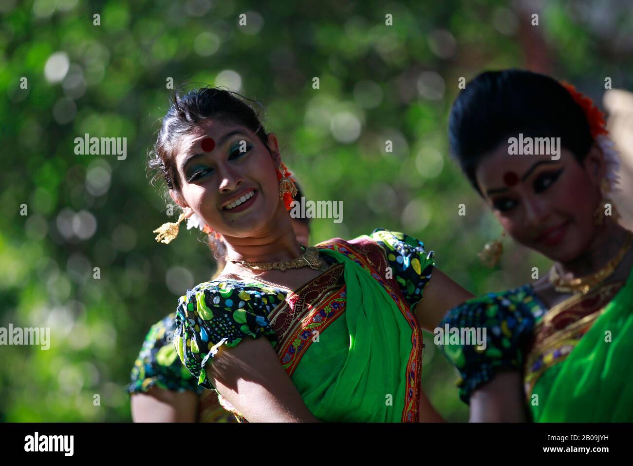 Women perform a dance at the Bakultala premises of the Fine Arts Institute of Dhaka University to mark the festival of harvest or Nobanno Utshab. The festival is held especially in the rural areas in late November to celebrate harvesting of Aman the main crop of the year in Bangladesh. Dhaka, Bangladesh. November 15, 2010. Stock Photo