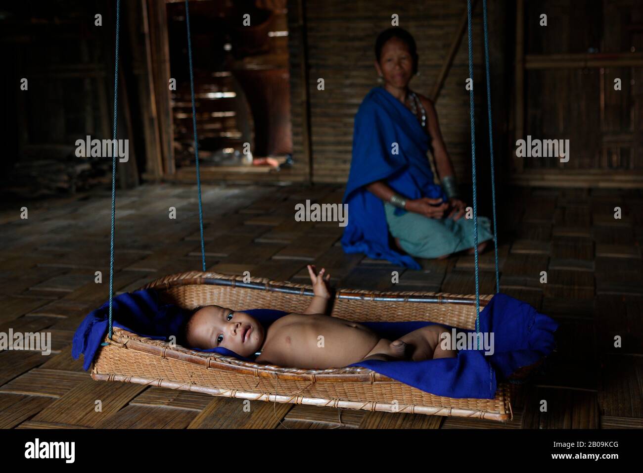 An infant in a cradle inside a Murong home, in Bandarban, Bangladesh. September 27, 2009. Stock Photo