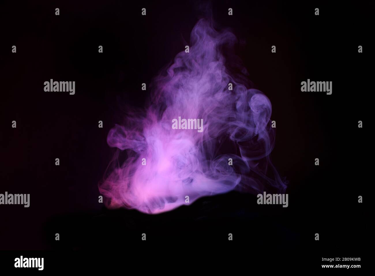 Abstract neon light smoke effect on black background. Smoke cloud explosion. Stock Photo
