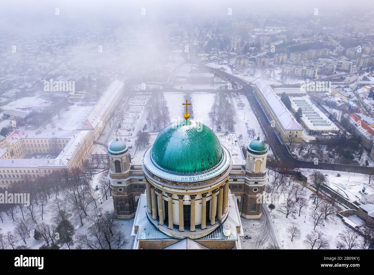 Esztergom, Hungary - Aerial view of the dome of the beautiful snowy Basilica of Esztergom on a foggy winter morning Stock Photo