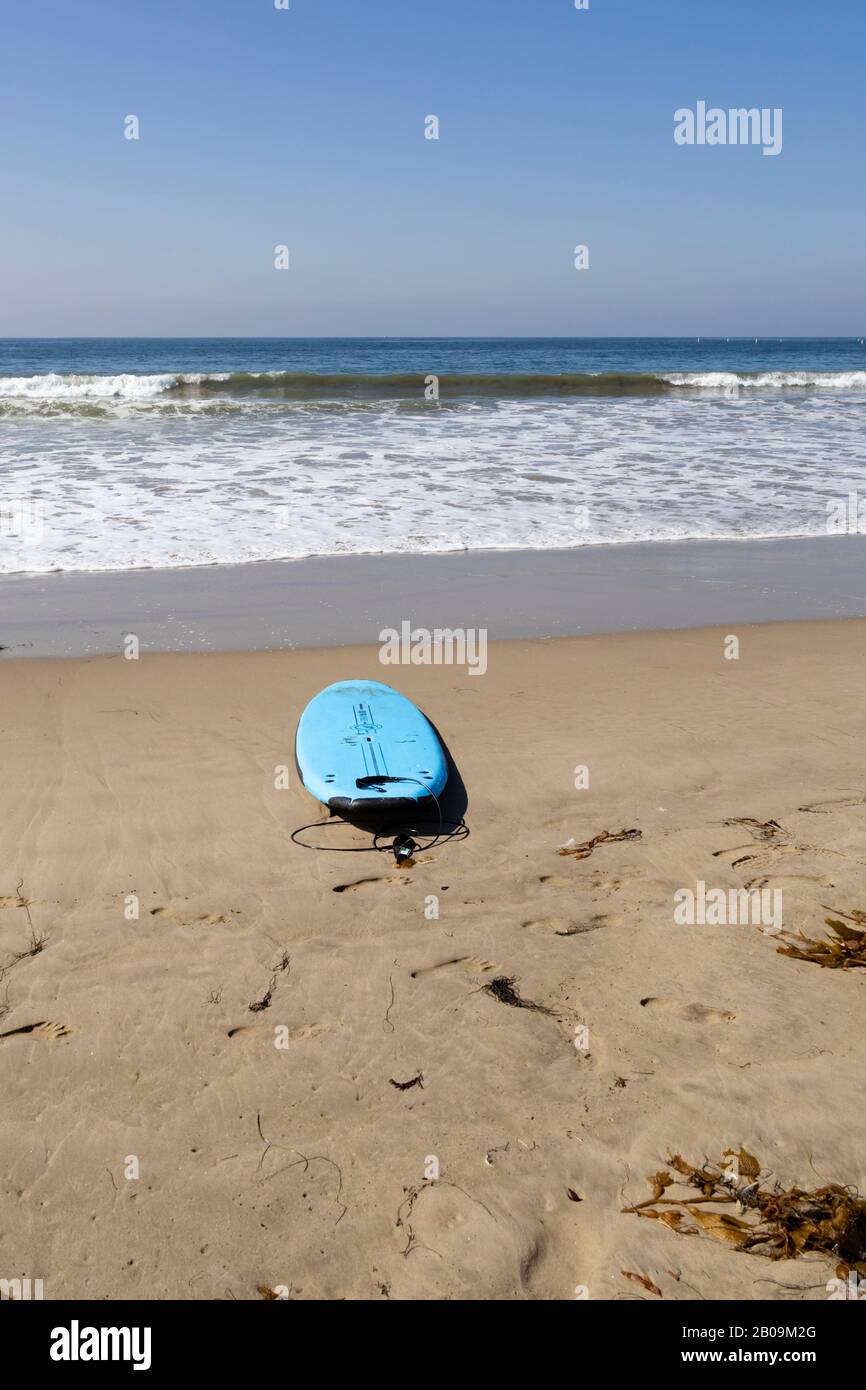 Abandoned surfboard on the sand at Santa Monica beach, California, United States of America Stock Photo