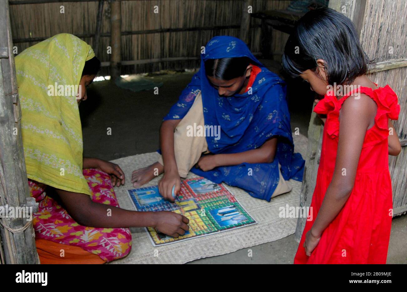 Rural girls play Ludo ( local board game) at a village in Faridpur