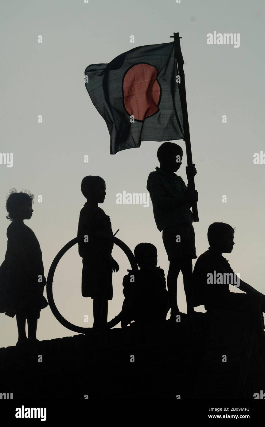 Silhouettes of children with the National flag on Victory Day or Bijoy Dibash of Bangladesh. Bijoy Dibash commemorates the day in 1971 (December 16) when 90,000 troops of the Pakistani occupation forces surrendered to the allied forces of Bangladesh and India at Suhrawardy Uddyan in Dhaka, ending a nine month long Liberation War against Pakistan. Dhaka, Bangladesh. December 16, 2008. Stock Photo