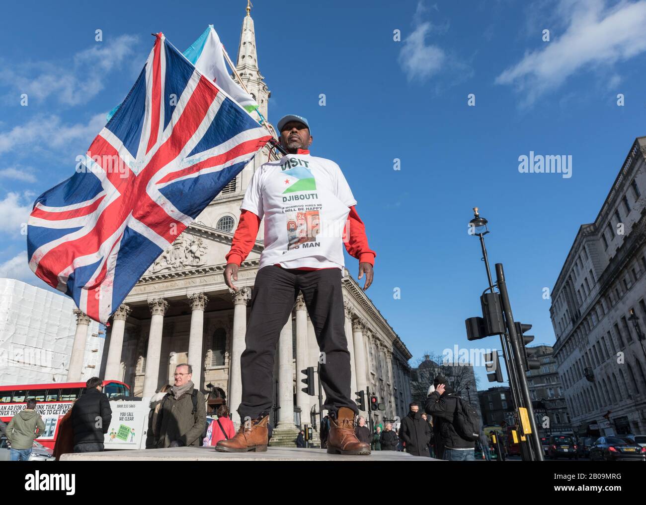 Flag man with Union Jack flag on Trafalgar Square advertising 'Visit Djibouti' on his shirt