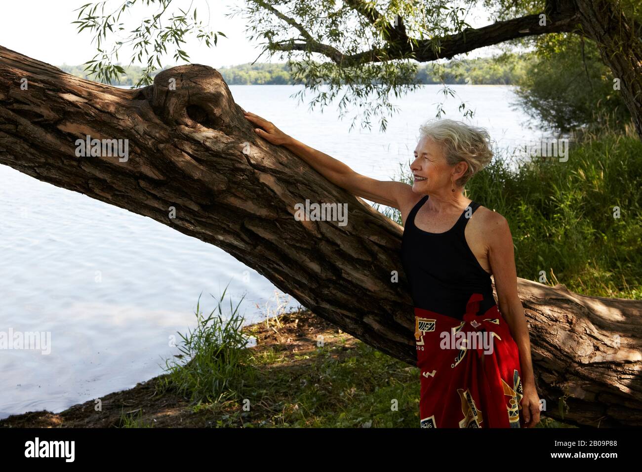 beautiful 65 year old woman swimming in lake Stock Photo