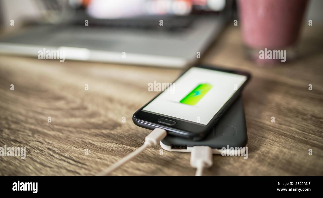 Charging mobile phone with power bank with charging mark on the screen Stock Photo Alamy