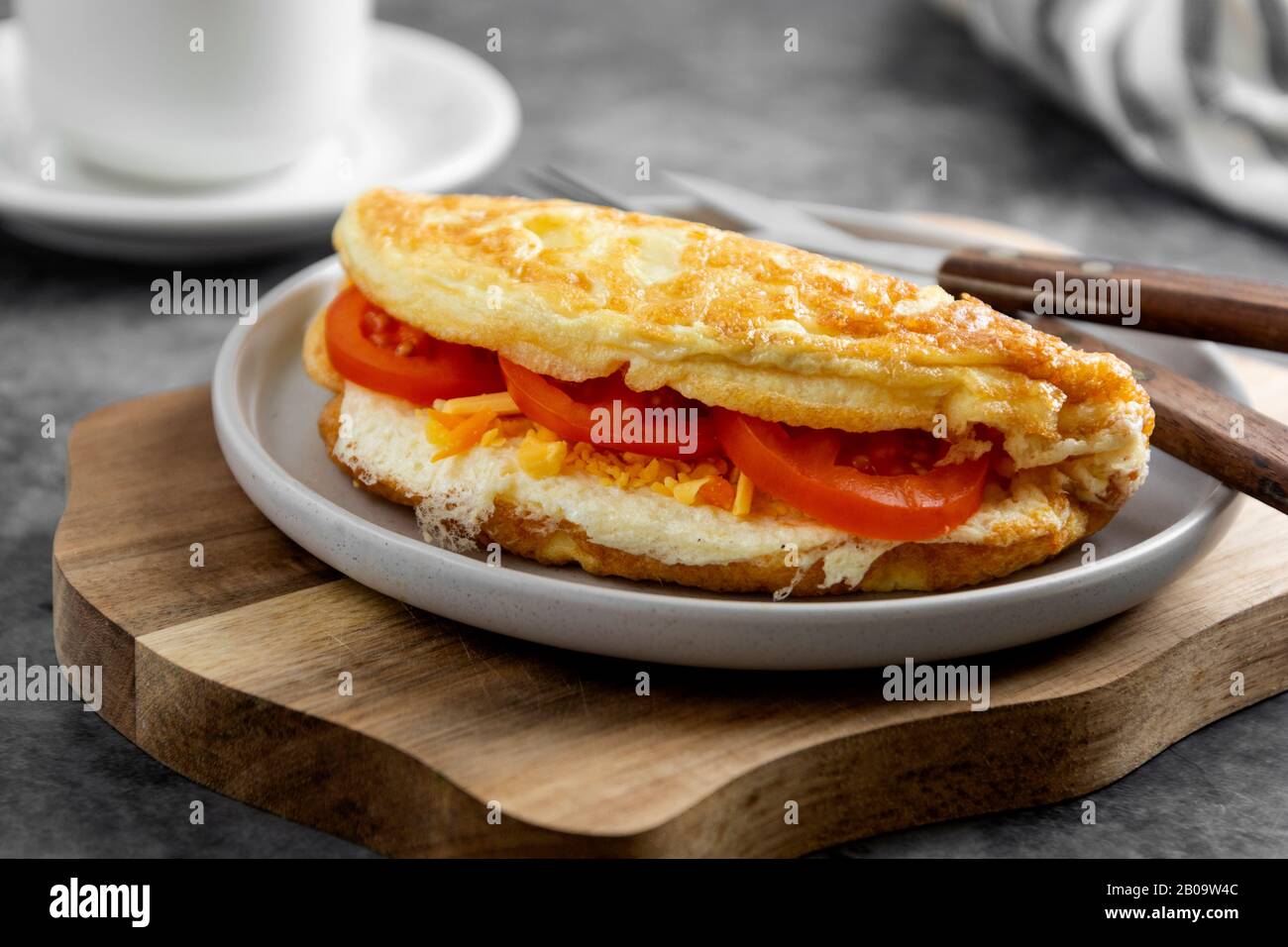 Omelet with cheese and tomatoes. Healthy homemade omelette for breakfast. Stock Photo