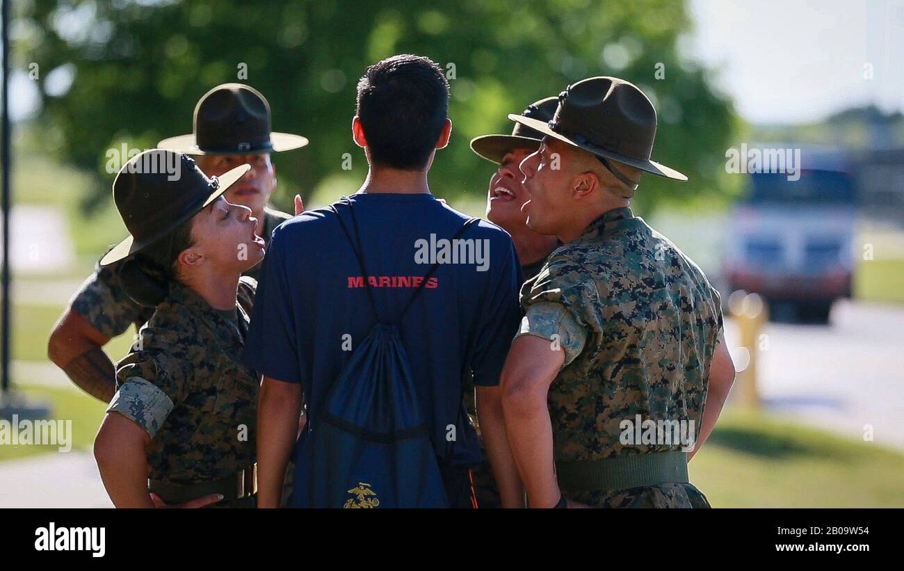 U.S. Marine Corps Drill Instructors shout at a recruit at Marine Corps
