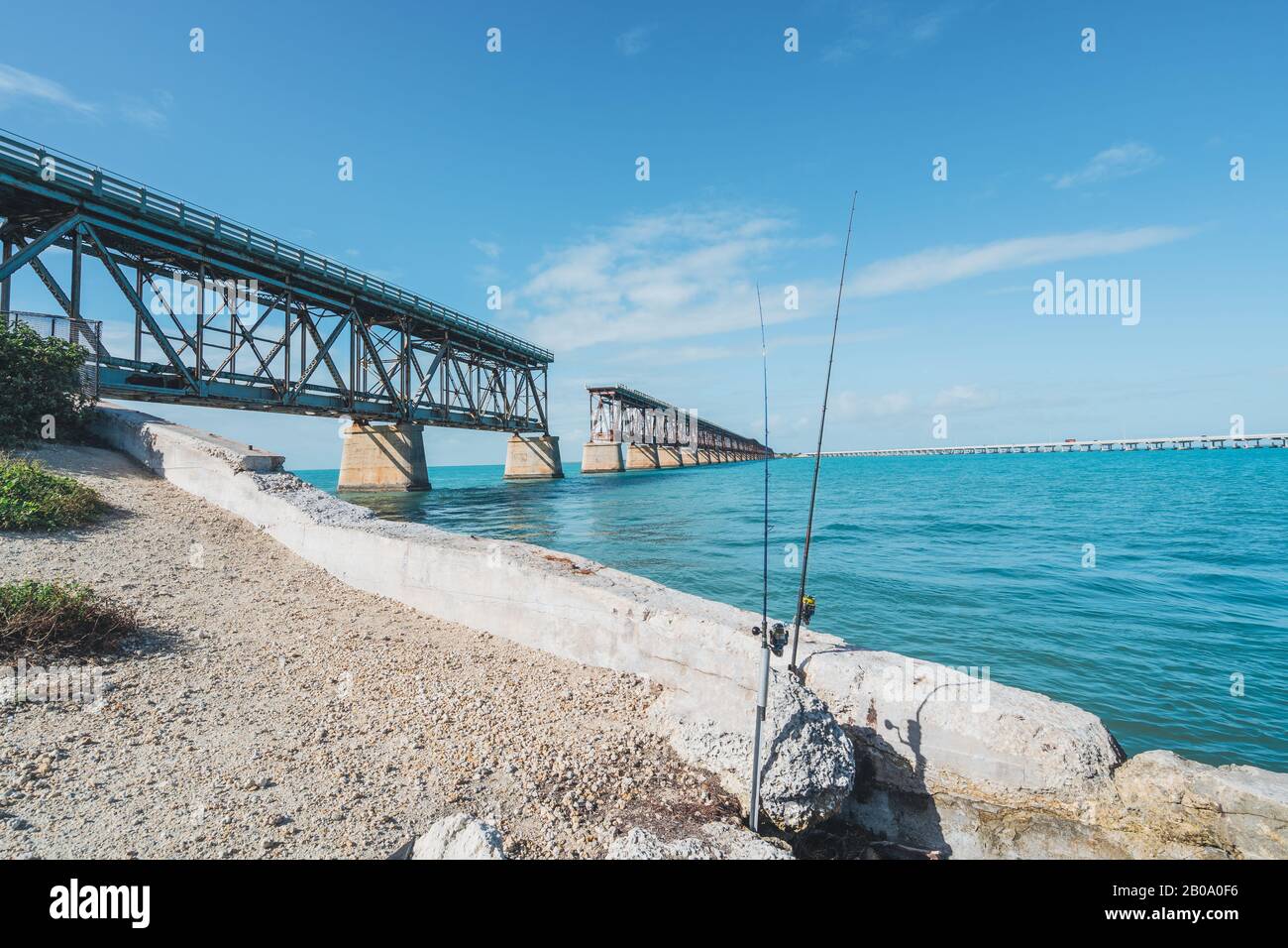 Bahia Honda State Park in the Florida Keys - fishing poles in front of old overseas highway bridge on beautiful sunny day Stock Photo