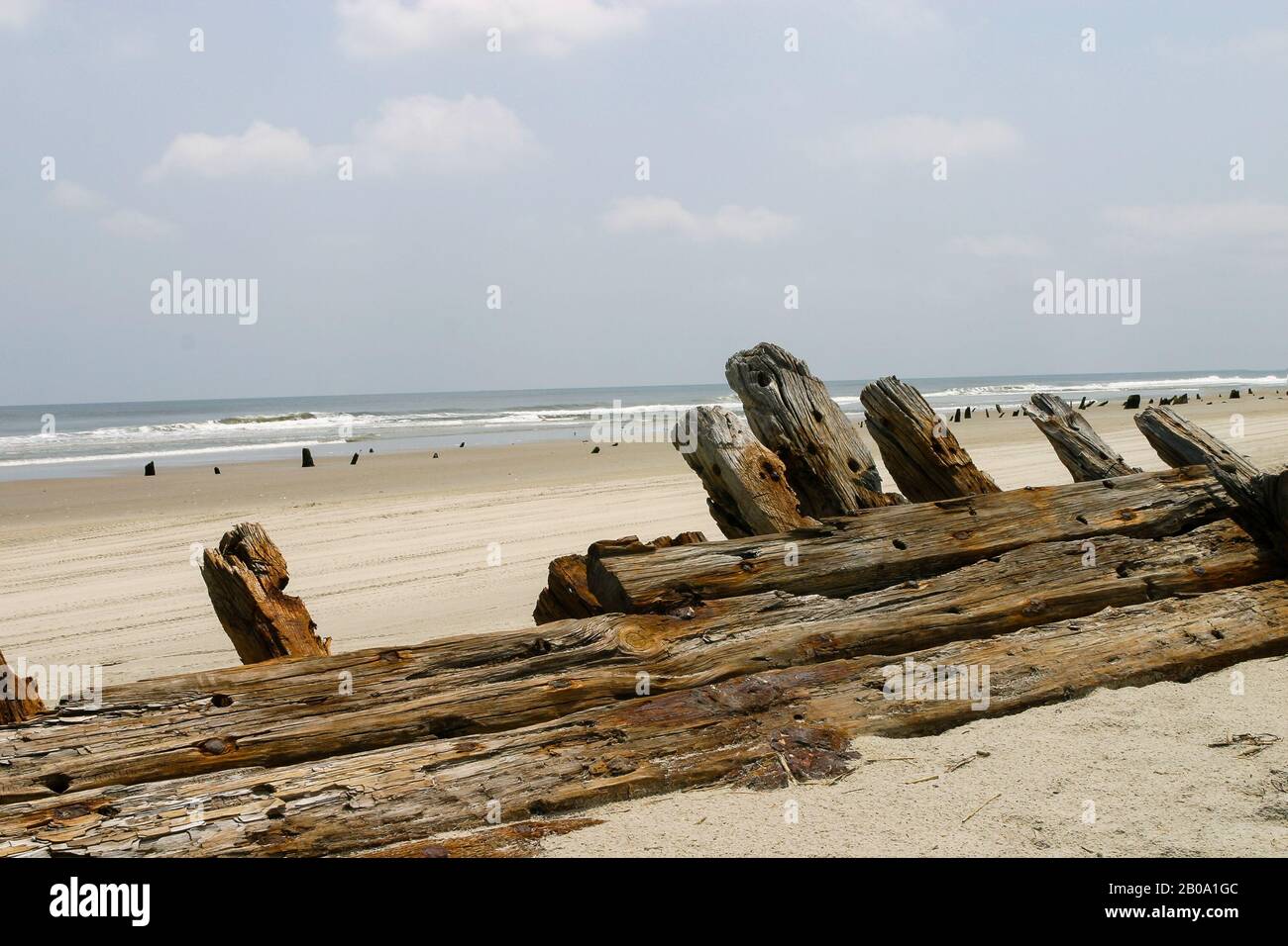 Relic, old wooden shipwreck hull uncovered on beach. Stock Photo