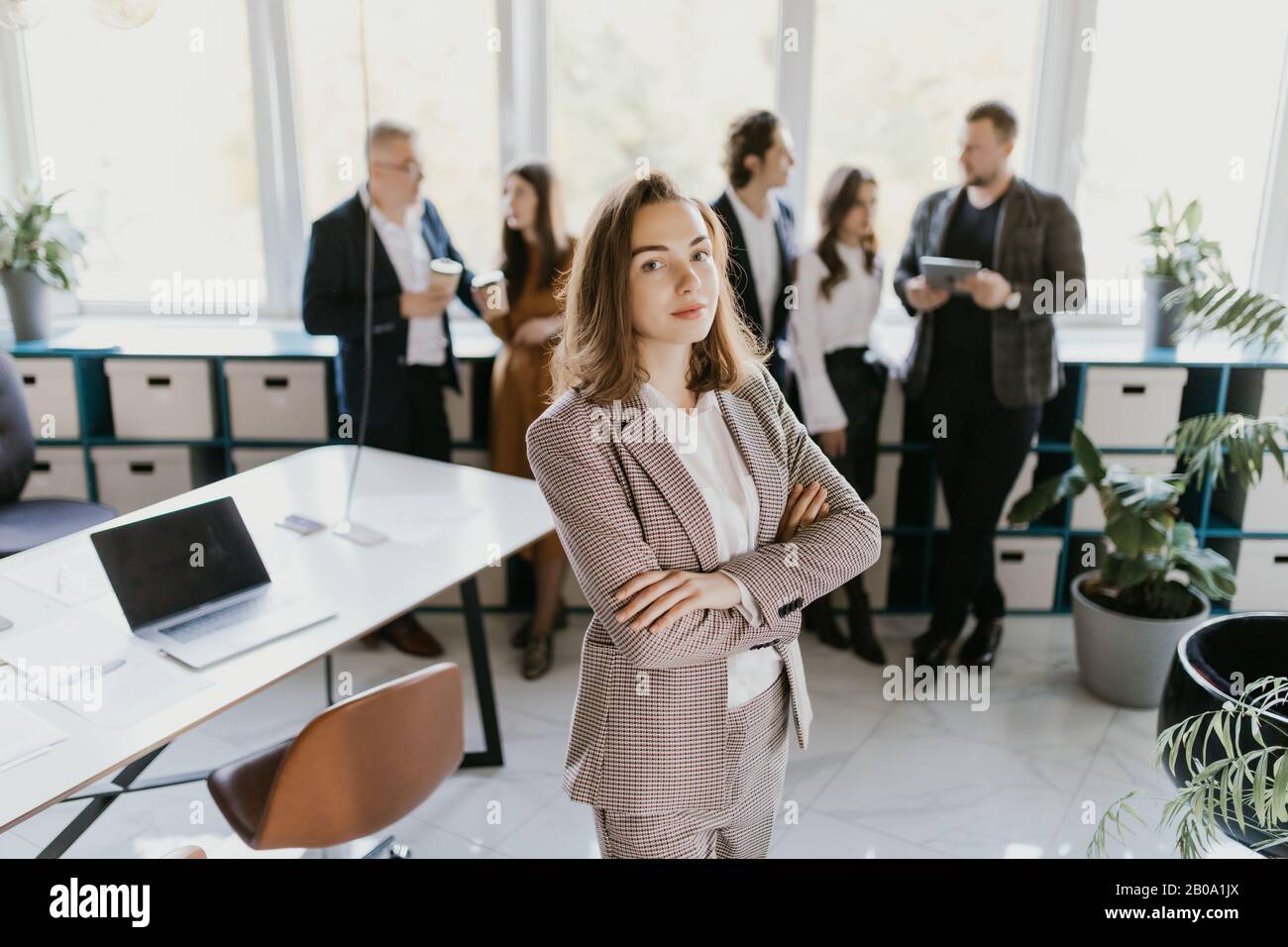 Female Business leader standing in front of her team Stock Photo - Alamy