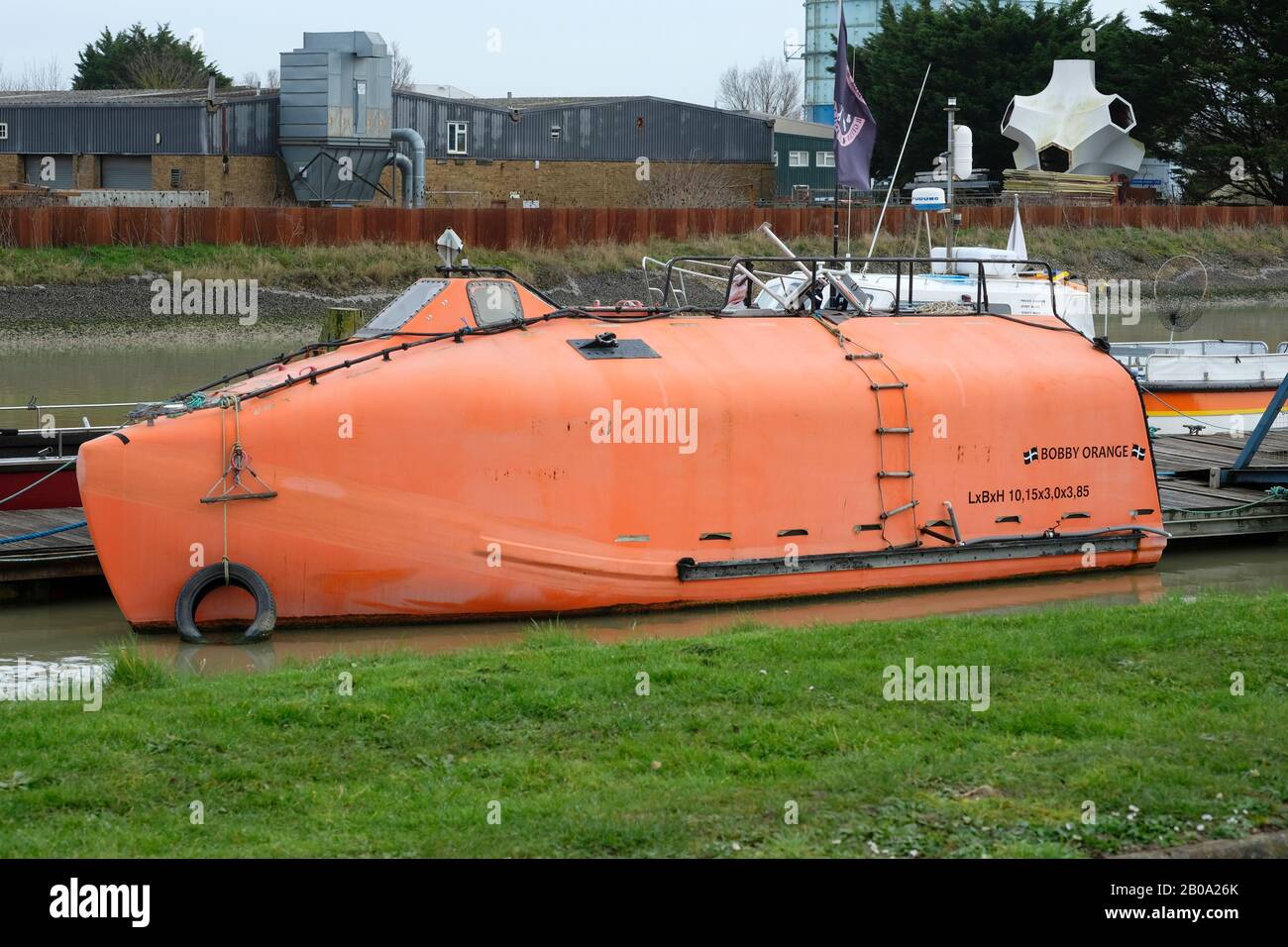 'Bobby Orange' a converted oil rig lifeboat moored at Littlehampton Marina, West Sussex, England Stock Photo