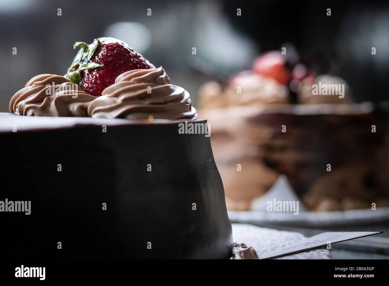 Chocolate cake with a strawberry on top Stock Photo - Alamy
