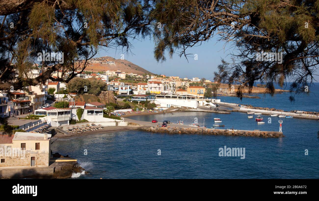 Early morning sunshine over the fishing village of  Panormos ( Panormo ) in Crete. Panormos is a small Cretan village on the Northern coast Stock Photo