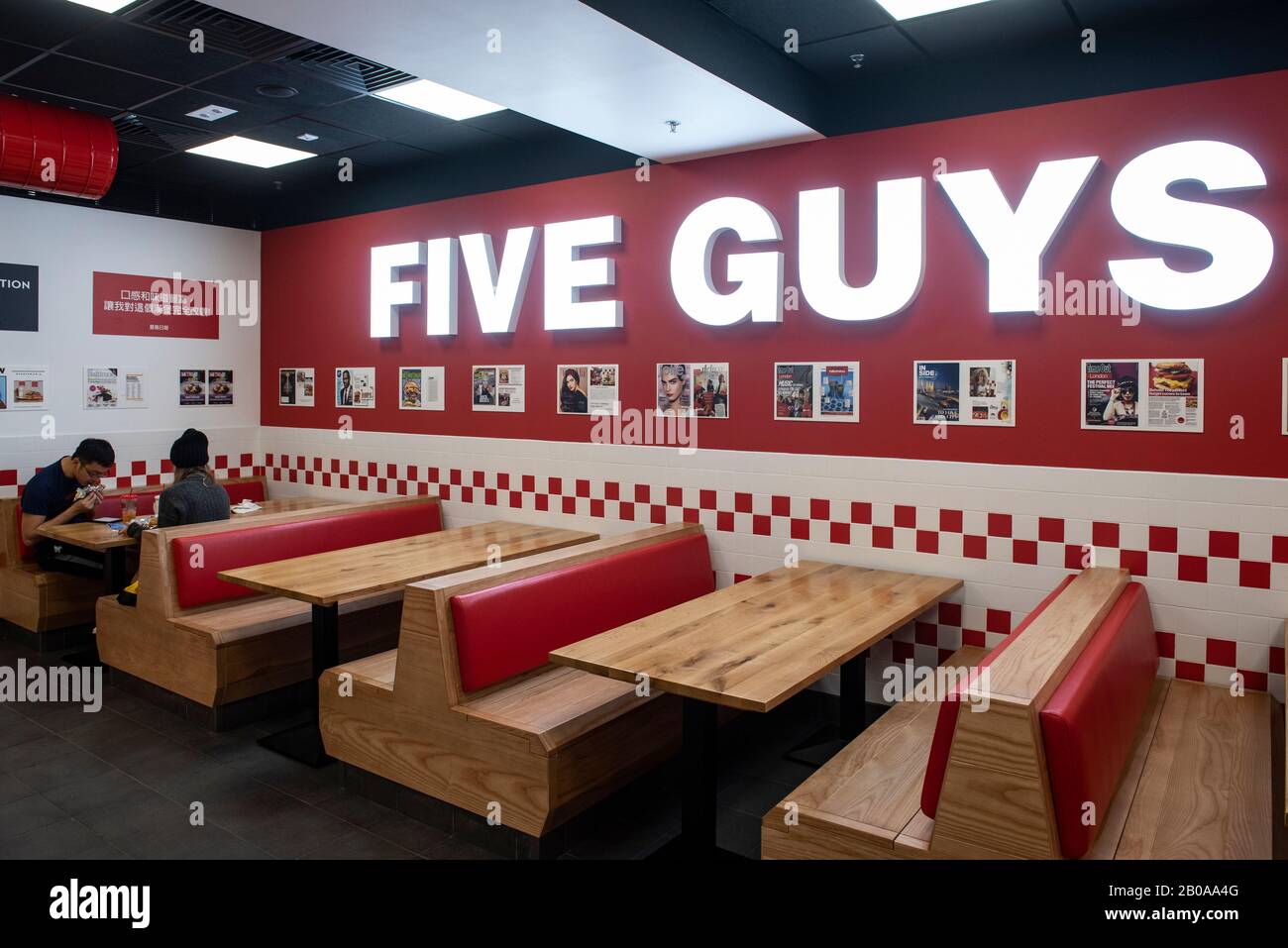 Customers eat at the American fast casual restaurant chain Five Guys in ...
