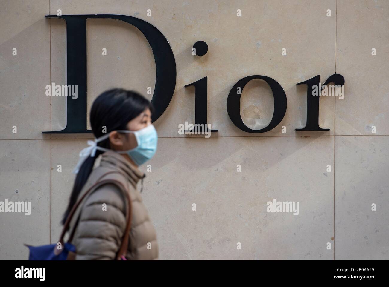 Download A Pedestrian Wearing A Face Mask Walk Past The French Christian Dior Luxury Goods Logo Seen In Hong Kong Stock Photo Alamy PSD Mockup Templates