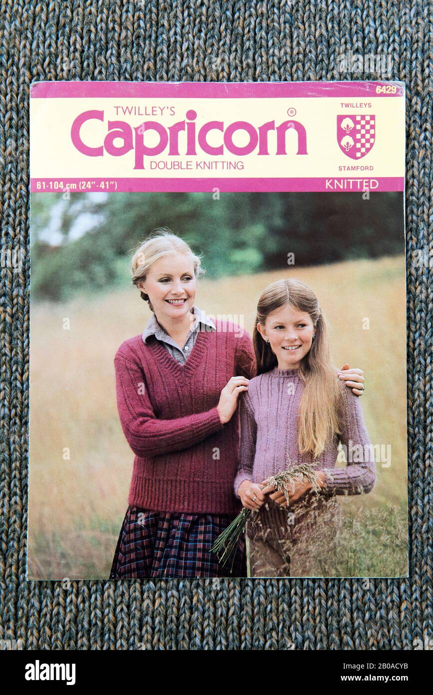 Twilley's Capricorn knitting pattern showing lady and young girl wearing jumpers, c.1970's displayed on knitted background. Stock Photo