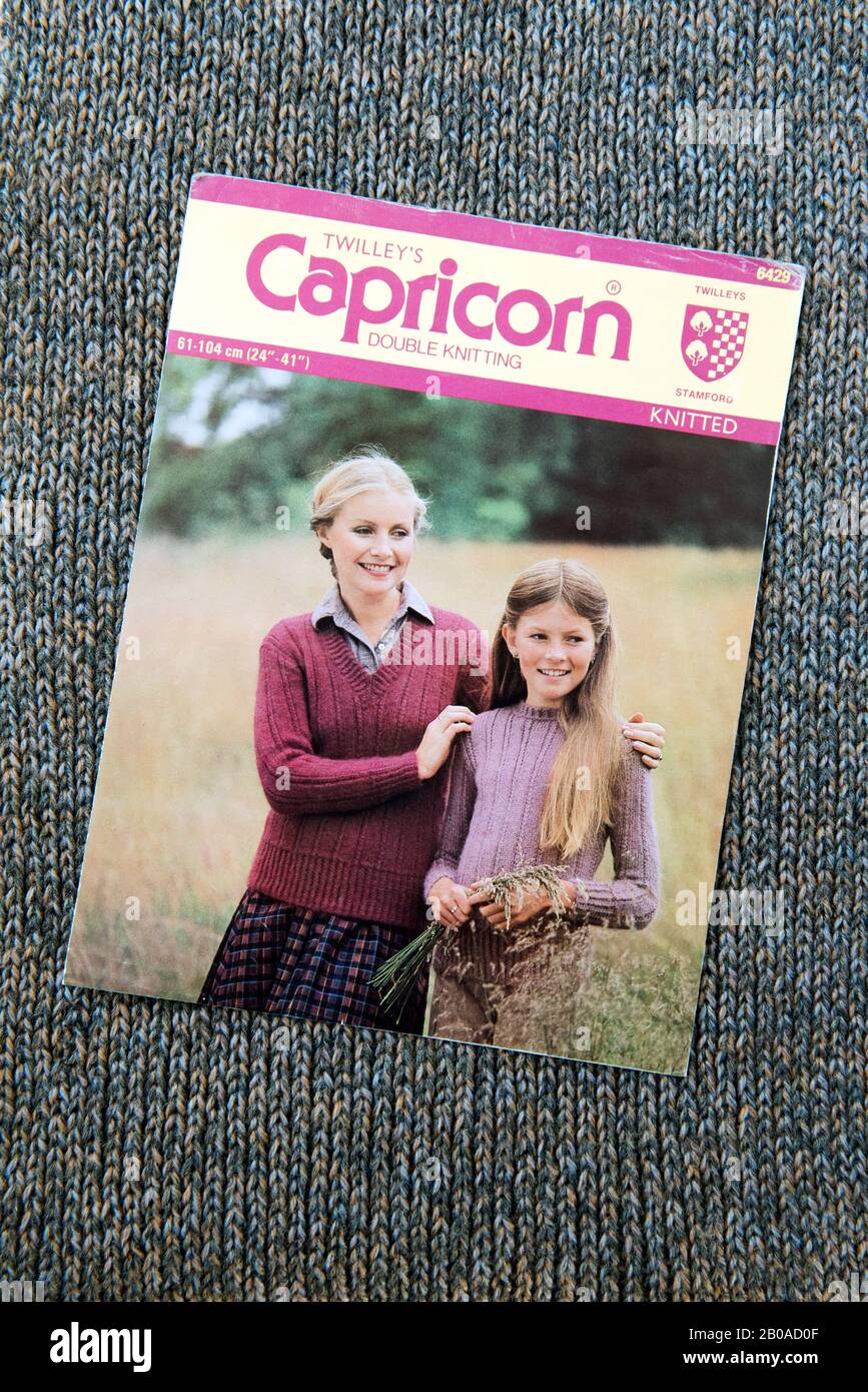 Twilley's Capricorn knitting pattern showing lady and young girl wearing jumpers, c.1970's displayed on knitted background. Stock Photo