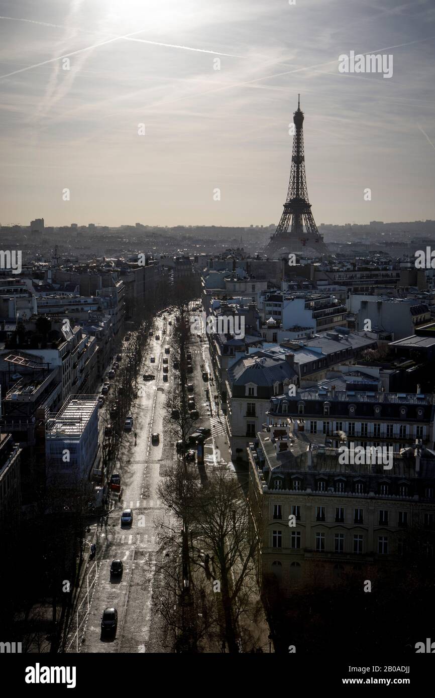 The sun rises behind the Eiffel Tower in Paris, France near New Years Stock Photo