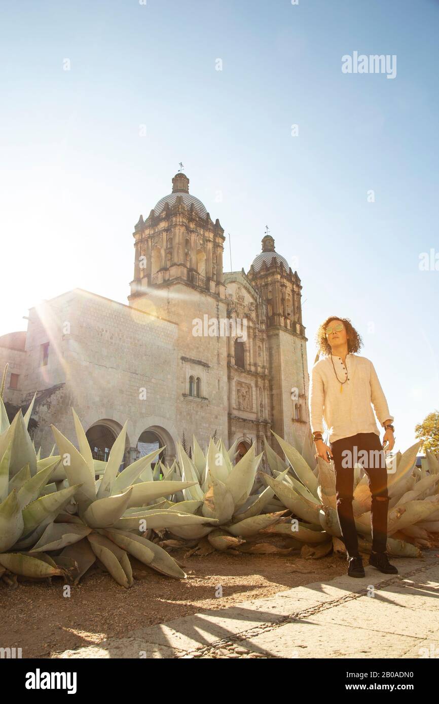 Man with curly hair style outside Catholic temple in Oaxaca Stock Photo