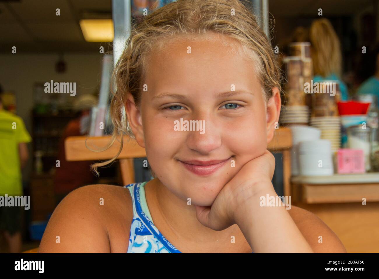 Young firl in diner smirking Stock Photo
