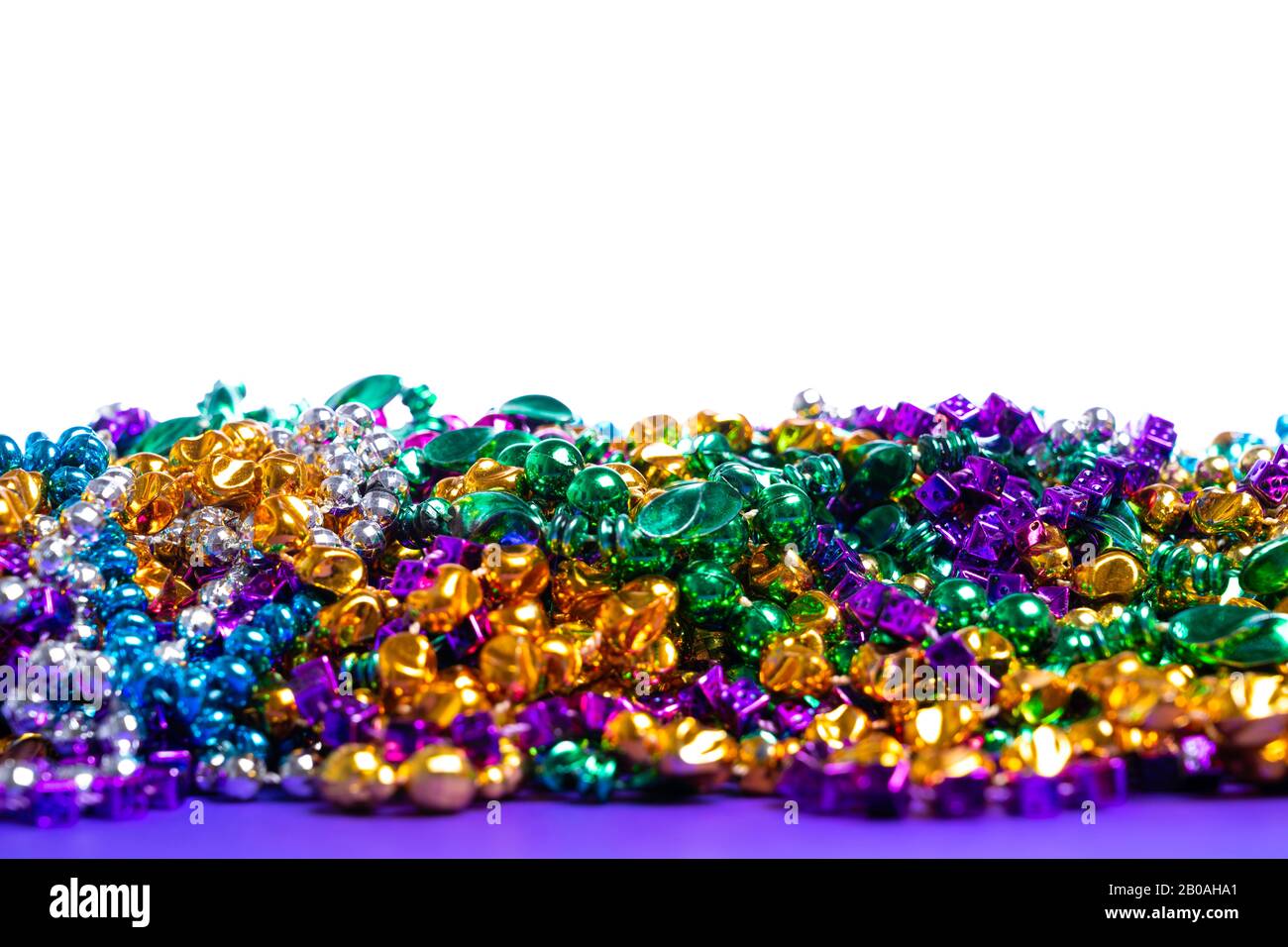 Mardi Gras beads on white background Stock Photo