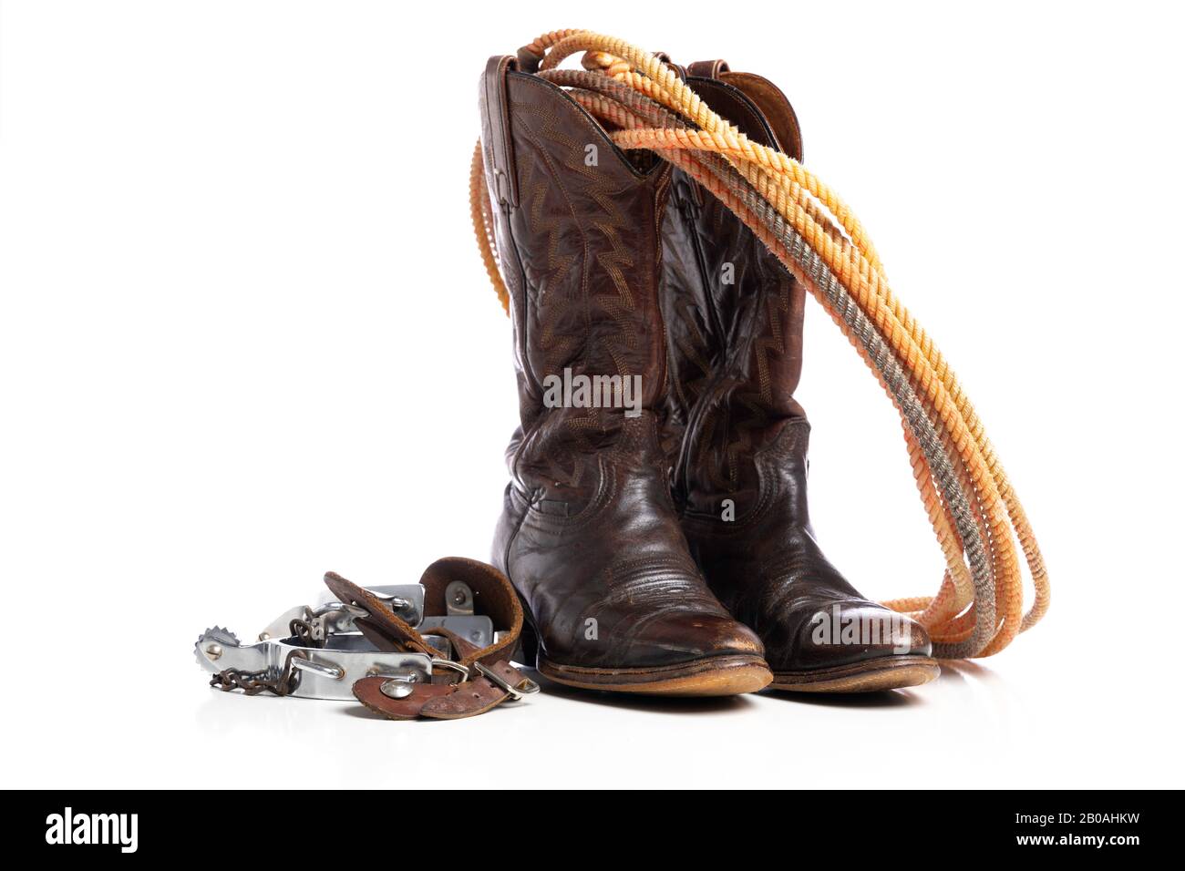 Western boots and a lap or lariat rope and spurs on a white background Stock Photo