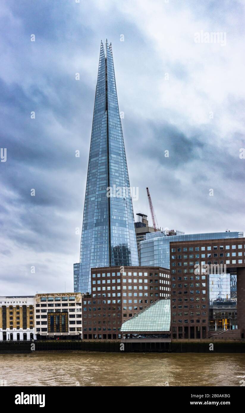 The Shard, tallest building in the UK, London Borough of Southwark, SE1 viewed across the River Thames on a dull winter day with dark stormy clouds Stock Photo