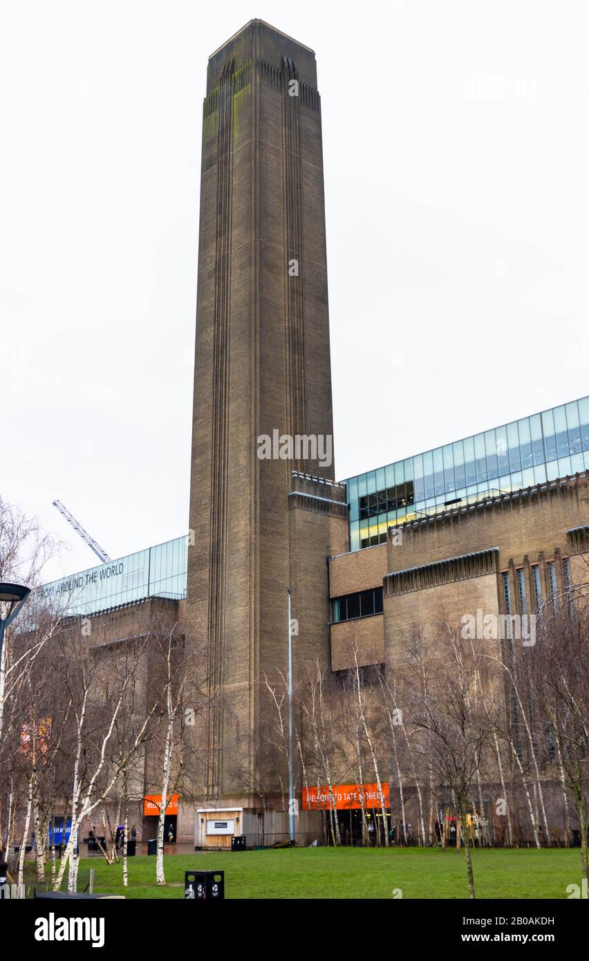 View of the exterior and iconic chimney of Tate Modern art gallery, Bankside, London SE1 on South Bank Embankment of the River Thames in bad weather Stock Photo